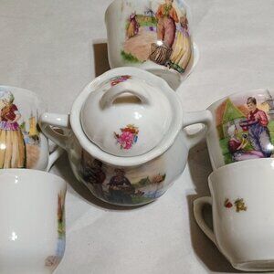 Vintage teacups and lidded tea pot with diffuser